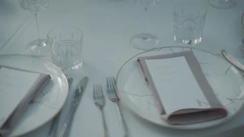 Wedding table, plates with invitation, close-up Stock Footage 220534258