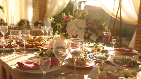 Wedding table rustic style decor with dishes, drinks and flowers in pink and Stock Footage 79840898