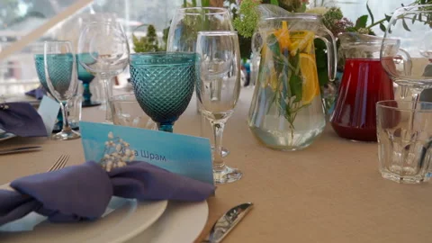 Wedding table serving with blue glasses and flowers. Close up Stock Footage 149777644
