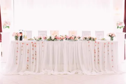 The wedding table set decorated with pink flowers. Stock Photos