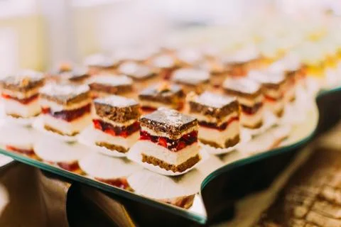 Wedding table set. The delicious chocolate cakes with strawberries. Stock Photos
