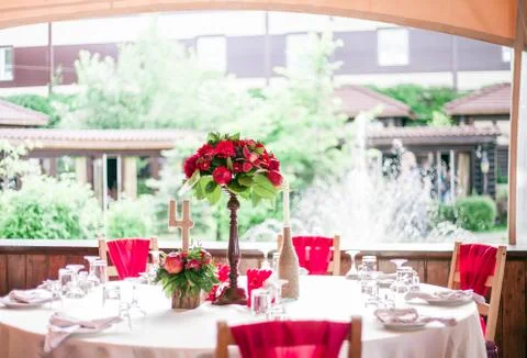 Wedding table set for fine dining or another catered event in red colors Fotos Stock