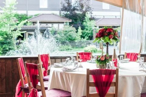 Wedding table set for fine dining or another catered event in red colors 写真素材
