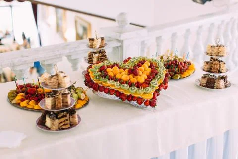 The wedding table set. The fruit plate in the form of heart. Stock Photos