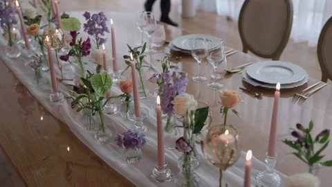 Wedding Table Set with Pink Taper Candles Bud Vases and Pastel Flowers Stock Footage 344436732
