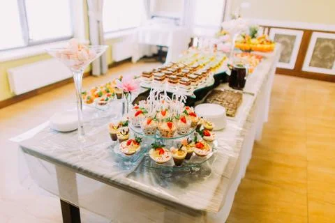The wedding table set. The stand full of different tasty desserts. Stock Photos