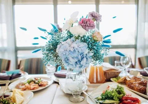 Wedding table setting. Beautiful blue and white bouquet of fresh flowers on t Stock Photos