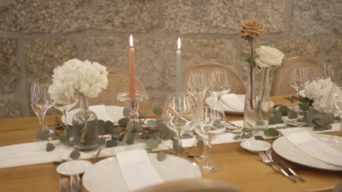 Wedding Table Setting with Candles and Flowers Against Stone Wall Venue Stock Footage 332948021