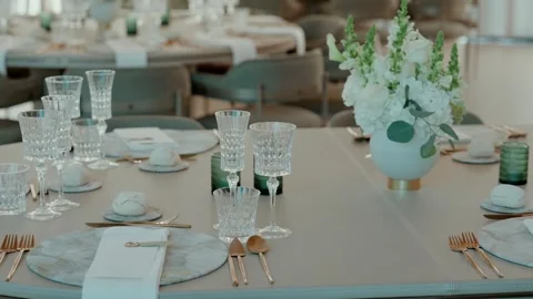 Wedding Table Setting with Crystal Glasses Gold Cutlery and White Flowers Stock Footage 343697901