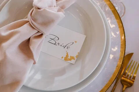Wedding table setting. Gold plate for the bride close-up. Stock Photos