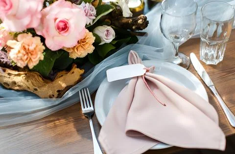Wedding table setting with pink roses and a blank name tag Stock Photos