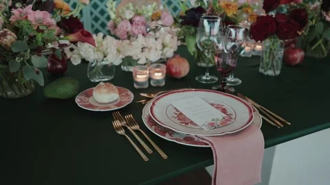 Wedding table setting with plate cutlery candles and floral decor Stock Footage 333106606