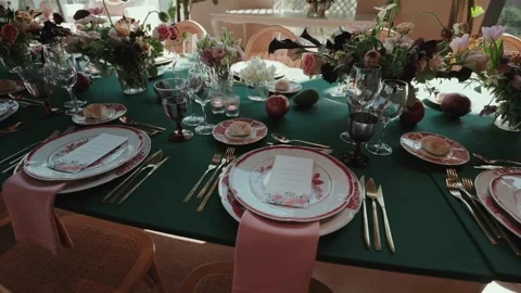 Wedding table setting with plates cutlery flowers and glassware Stock Footage 333110771