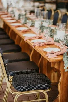 Wedding table setting in a restaurant decorated with flowers and candles Stock Photos