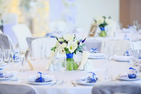 Wedding table setting in the restaurant on the white and blue background. Stock Photos