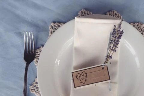 Wedding table setting sprig of lilac with a sign for the guest's name Stock Photos