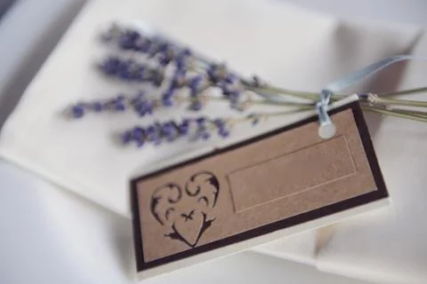 Wedding table setting sprig of lilac with a sign for the guest's name Stock Photos