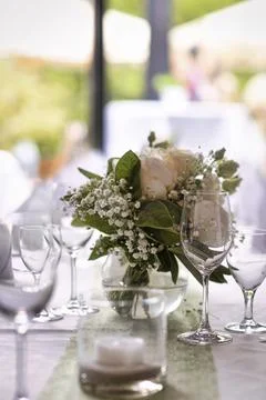 Wedding table setting with wine glasses and flower bouquets Foto stock
