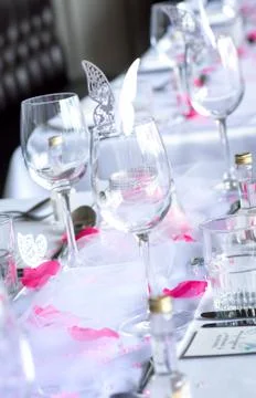 Wedding table setup with wine glasses and petals Stock Photos