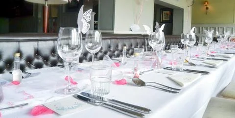 Wedding table setup with wine glasses and petals Stock Photos