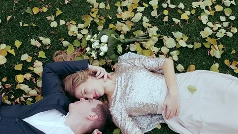 Wedding theme, the bride and groom are in the maple leaves on grass Video stock 74431488