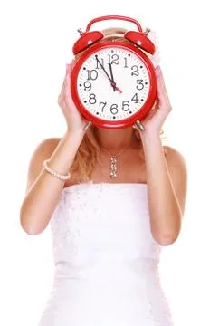 Wedding time. portrait bride with clock covering her face. Stock Photos
