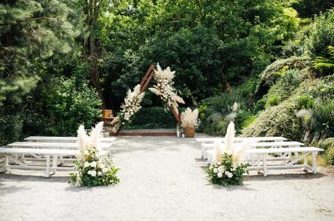 Wedding triangular arch with roses on the background of nature Stock Photos