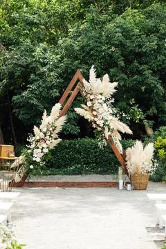 Wedding triangular arch with roses on the background of nature Stock Photos