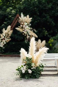Wedding triangular arch with roses on the background of nature Stock Photos