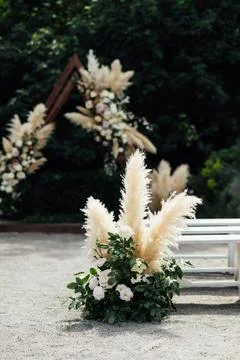 Wedding triangular arch with roses on the background of nature Stock Photos