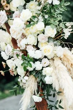Wedding triangular arch with roses on the background of nature Stock Photos