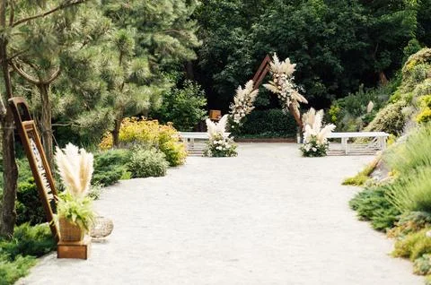 Wedding triangular arch with roses on the background of nature 스톡 사진