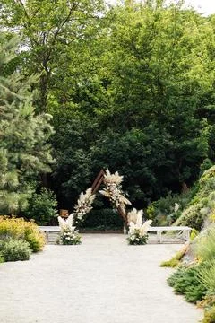 Wedding triangular arch with roses on the background of nature 스톡 사진