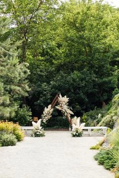 Wedding triangular arch with roses on the background of nature Stock Photos