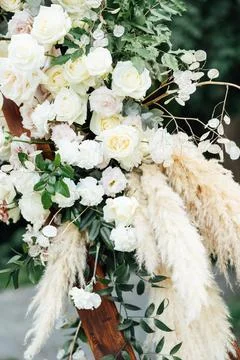 Wedding triangular arch with roses on the background of nature Stock Photos