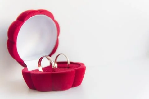 Wedding two gold ring in red box isolated on a white background Stock Photos