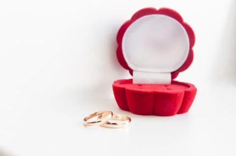 Wedding two gold ring in red box isolated on a white background Stock Photos