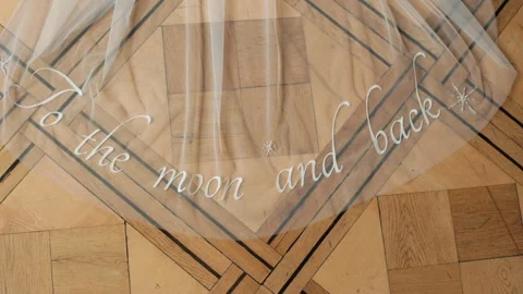 Wedding veil is elegantly spread out on floor, with delicate embroidery spelling Stock Footage 287589044