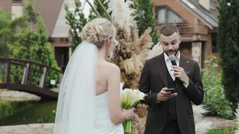 A wedding video captures the bride and groom sharing vows filled with love Stock Footage 322051749