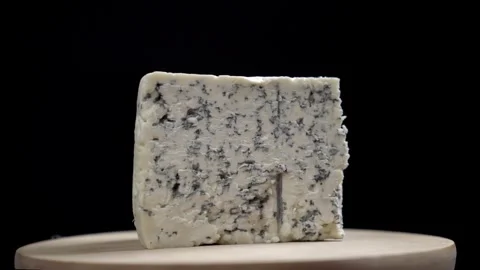A wedge of roquefort cheese rotating with a black background Stock Footage 241497767