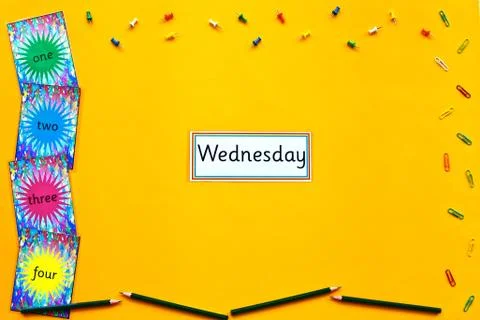 Wednesday learning flatlay on yellow background. Stock Photos