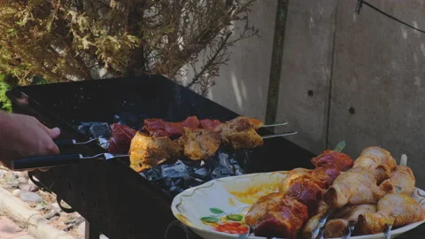 Weekend Barbecue - Loading Chicken Legs &amp; Shish Kebabs onto a Grill Stock Footage 148393027