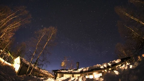 Weekend cottage winter night star clear sky timelapse 4 hours winter sweden Stock Footage 89975708