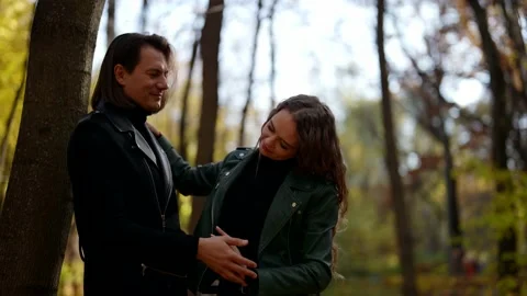 Weekend in park, loving spouses are walking together in forest in autumn day Stock-Footage 166103094