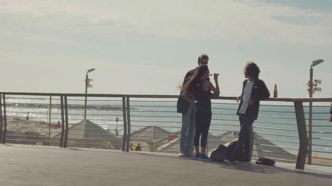 At the weekend people are drinking beer and chatting on the beach in Tel Aviv. Video stock 98214393