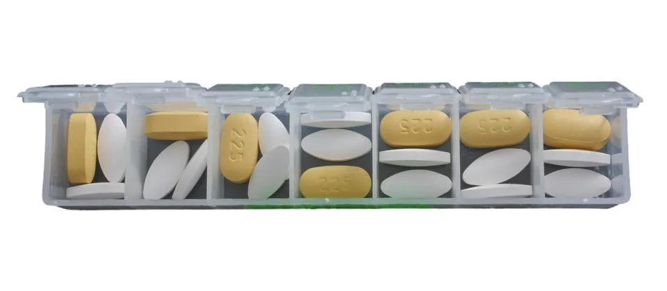 Weekly container with pills Stock Photos