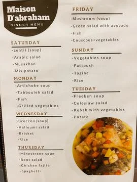 Weekly dinner menu board with daily dishes and meal options at Maison D'abr.. Stock Photos