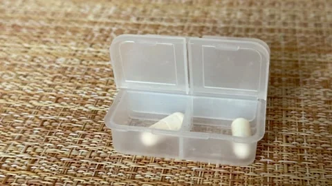 The weekly transparent pill box is designed for convenient and efficient daily Stock-Footage 316389843