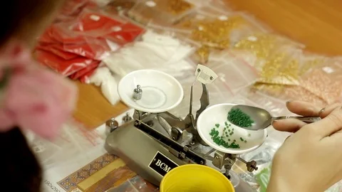 Weighed bead on the scales Stock Footage 69776022