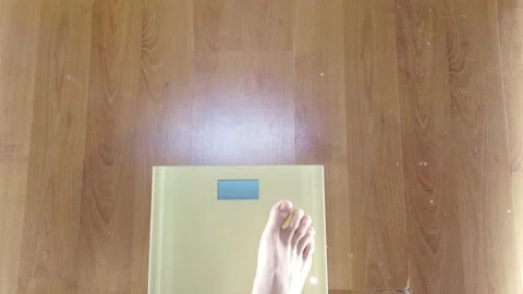 Weighing body weight on a scale, first-person view Stock Footage 146970520